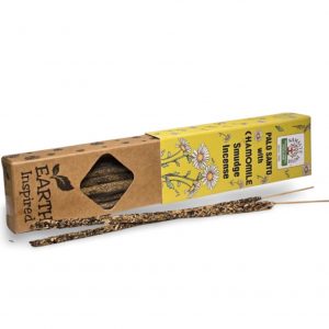 Varilla de incienso orgánico de camomila con palo santo sobre fondo blanco, aroma floral suave y purificador